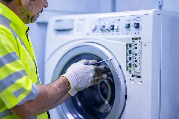 Um técnico de manutenção verifica um painel elétrico com ferramentas.